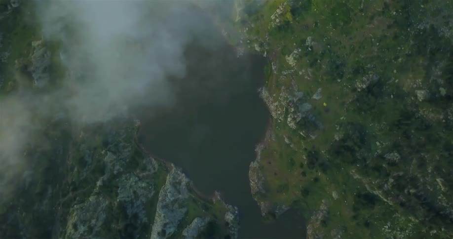 Clouds floating over small lake in wilderness