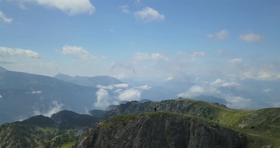 Hikers stand on a rocky cliffside