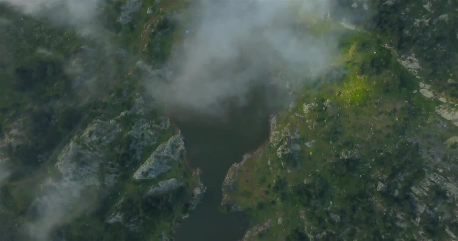 Clouds floating over small lake in wilderness