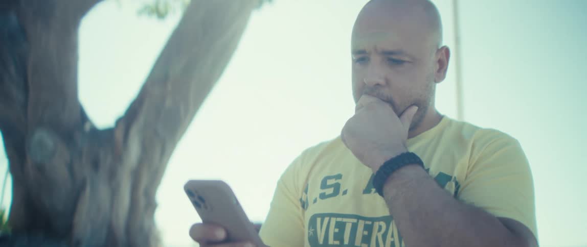 A man looking at a phone outdoors