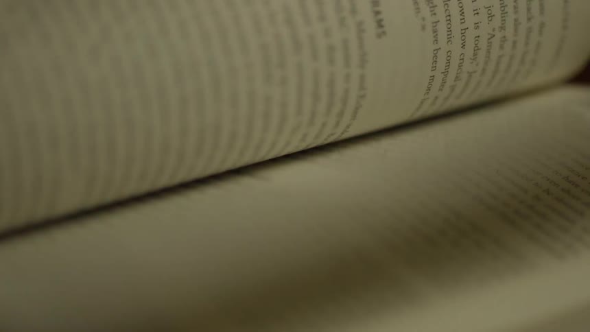 A close up view of some pages from a book being flipped through