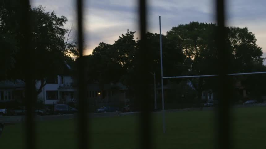 A green field is near a home