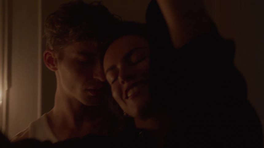 Couple dancing together under soft light in an intimate setting