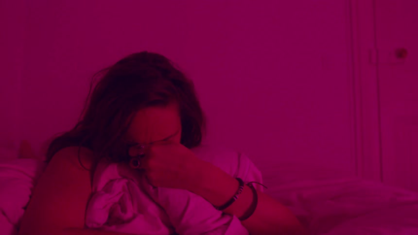 The scared woman in bed starts crying