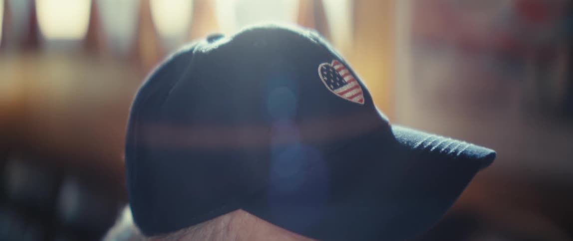 The man is wearing a blue baseball cap