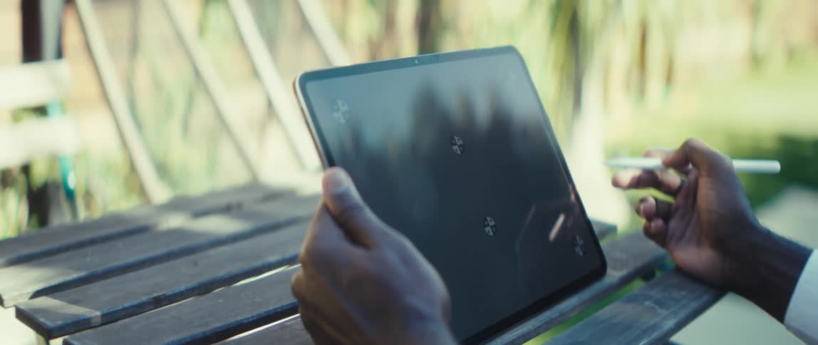 A man working on a tablet outdoors