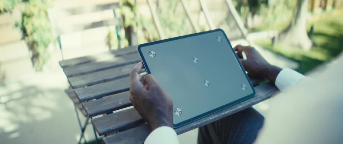 Person in a white shirt uses a stylus on a tablet