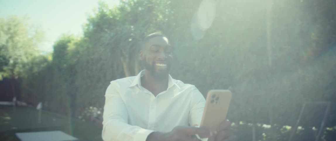 Smiling man interacting with his smartphone