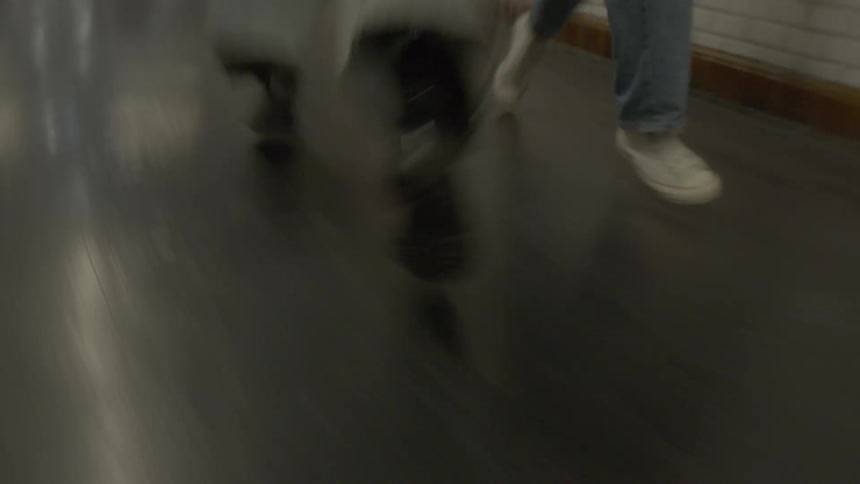 Two people run through the subway