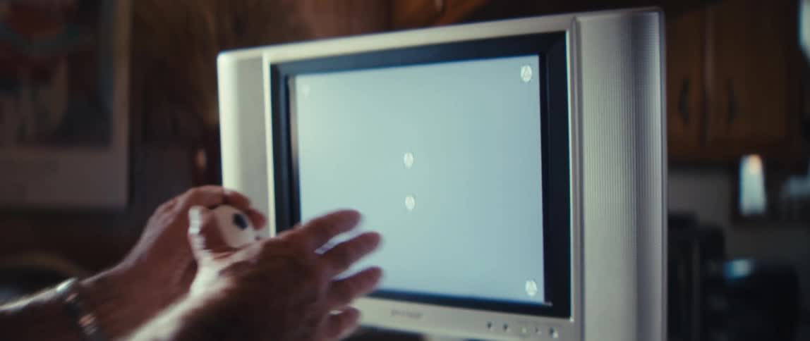 Happy elderly man watching television