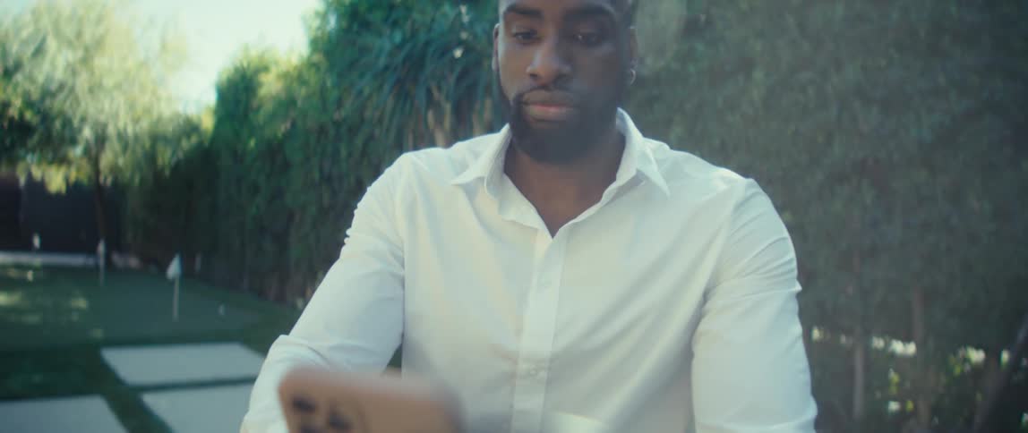 A portrait of a man sitting outdoors