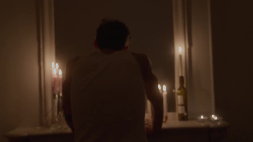 The man leans in front of the mirror