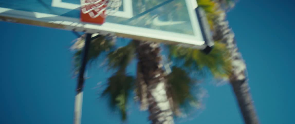 A man playing basketball outdoors