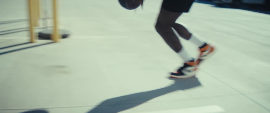 Man playing basketball outdoors