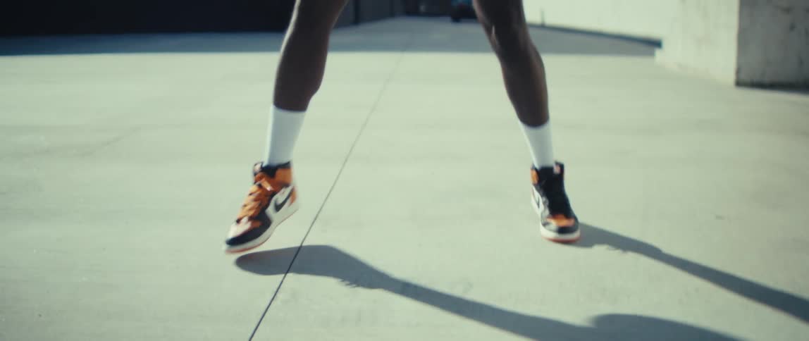 The man is dribbling the basketball