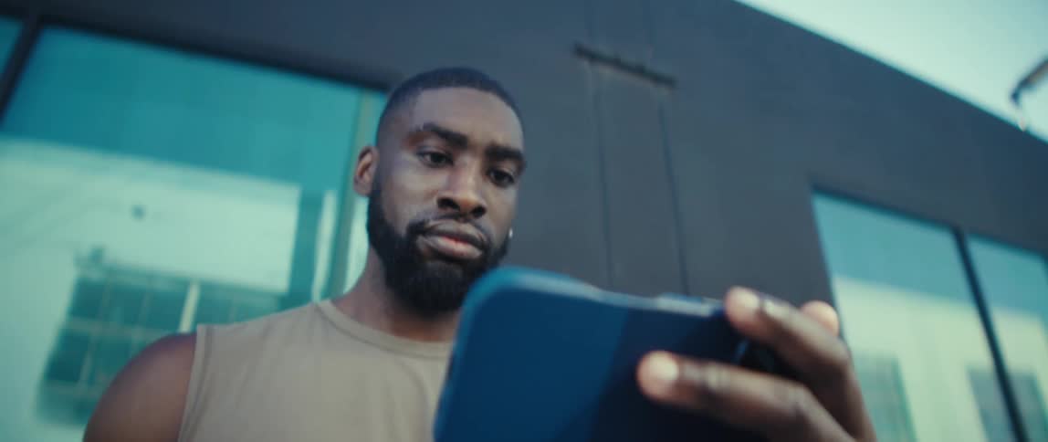 A man looking at his phone outdoors