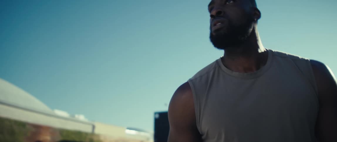 Man holding a basketball preparing to shoot outdoors