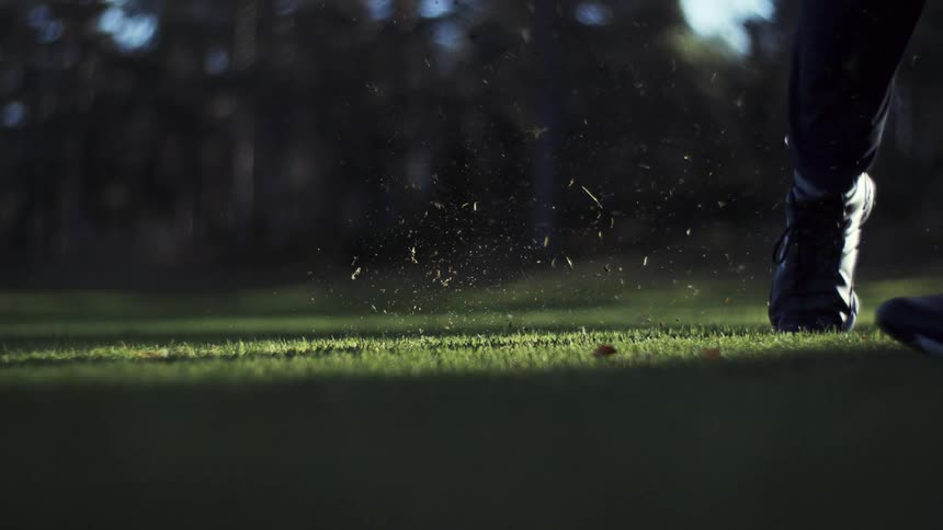 Golf club lifting a chunk of grass while striking the ball