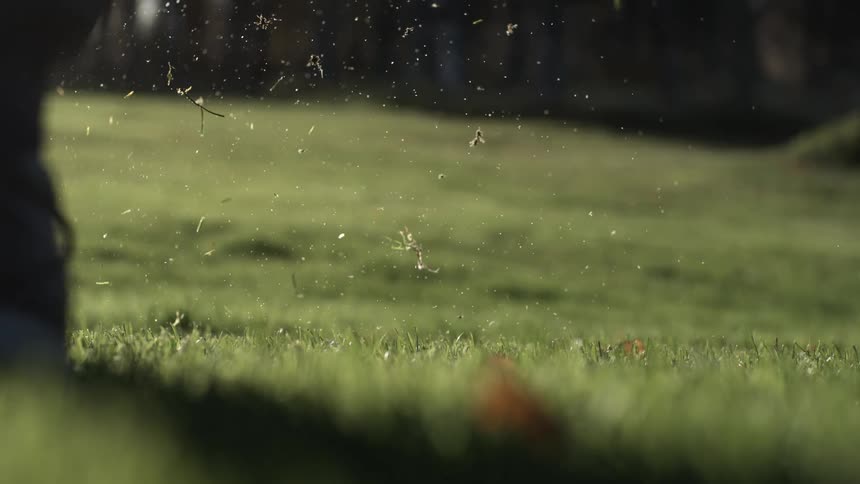 Golf club strikes the golf ball while a golfer plays outdoors during the daytime