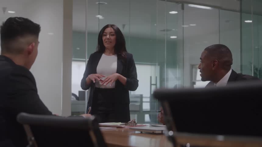 Woman presenting an idea to colleagues during a meeting in an office