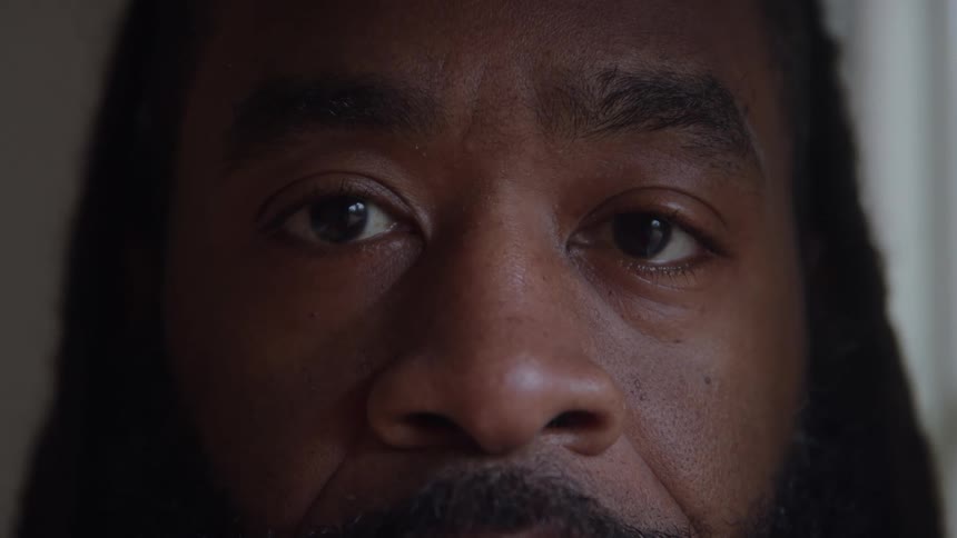 Closeup of a mans face with a serious expression and intense gaze