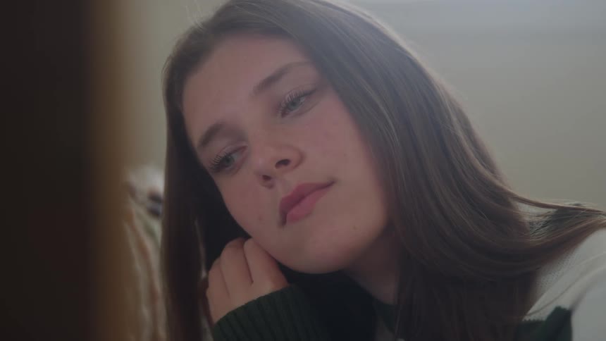 A girl puts in an earring