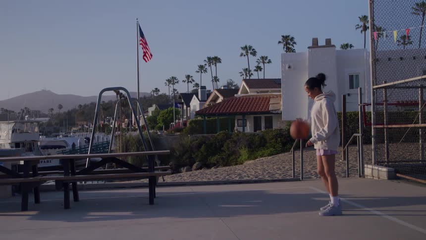 A girl dribbles a basketball