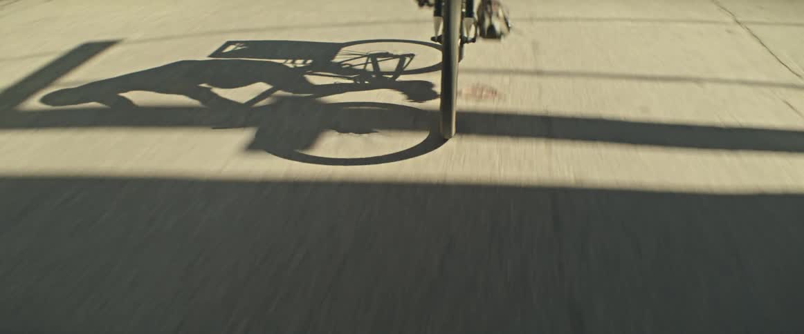 Front wheel of a bicycle moving along a paved street
