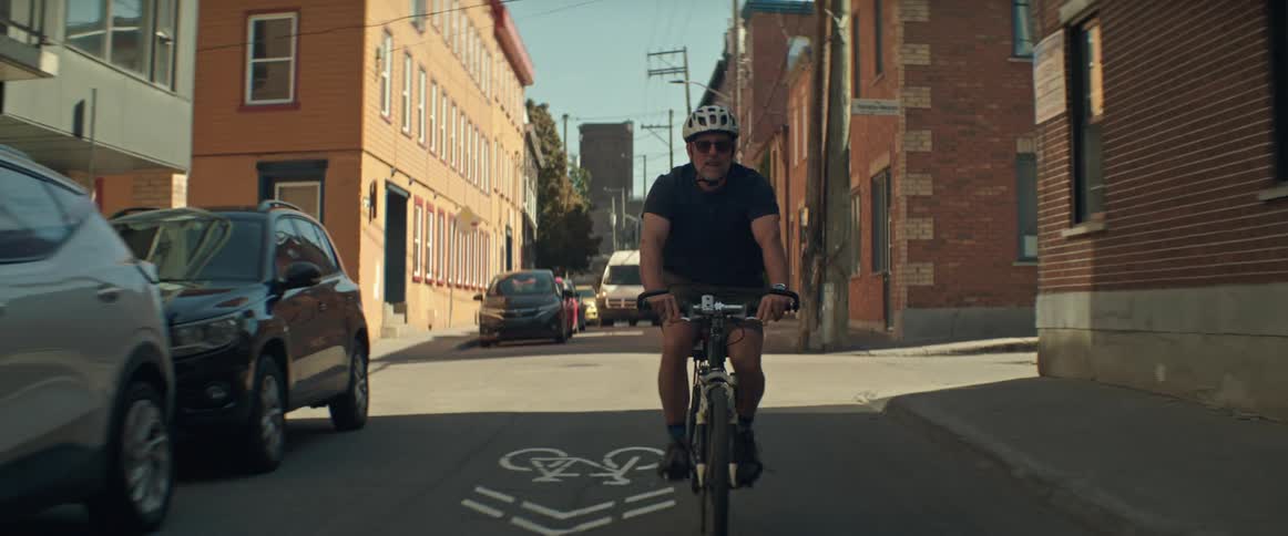 A man is riding his bike through city streets