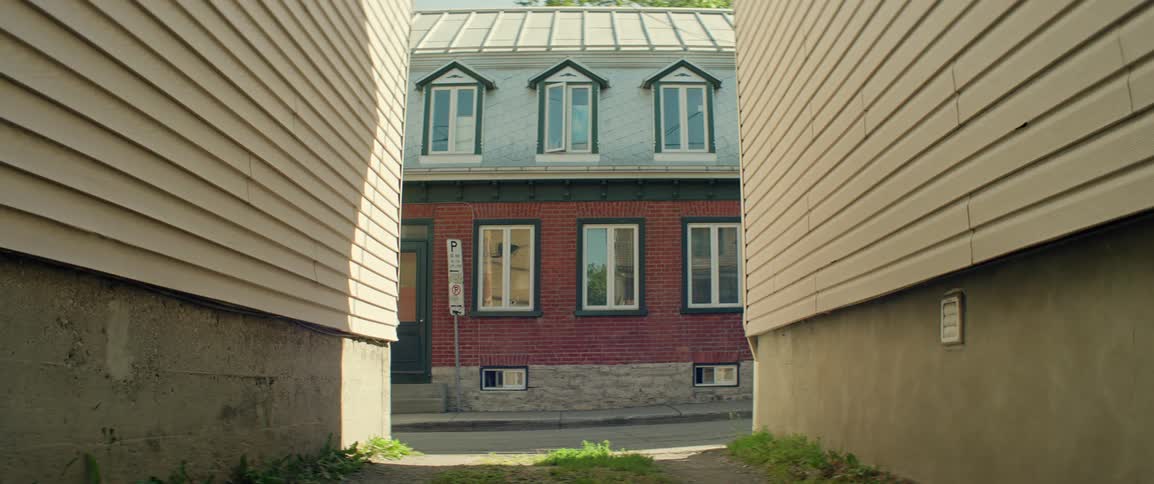 A person on a bicycle rides up a residential street