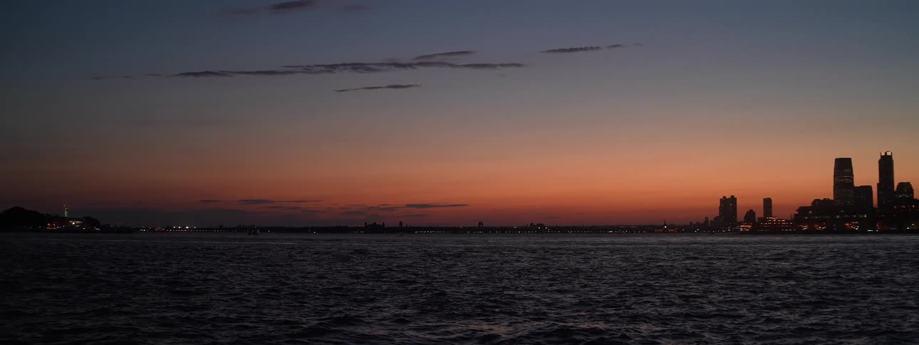 Horizon seen from the sea at dusk with orange tones in the sky