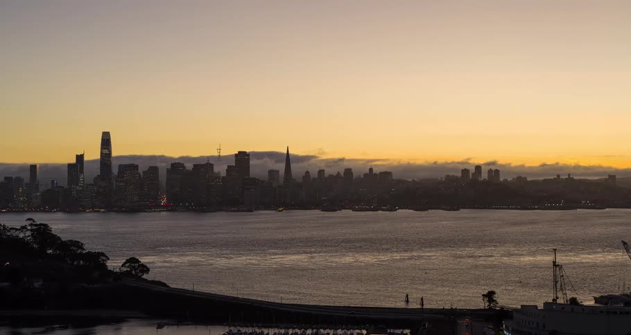 A view of some buildings in a city at sunset