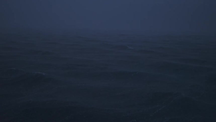 Dark waves move under dense fog at dusk