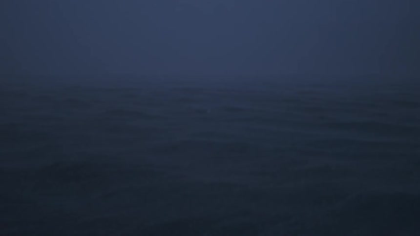 Waves in the ocean can barely be seen at night