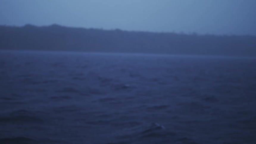 Water ripples and waves as rain falls along the coast