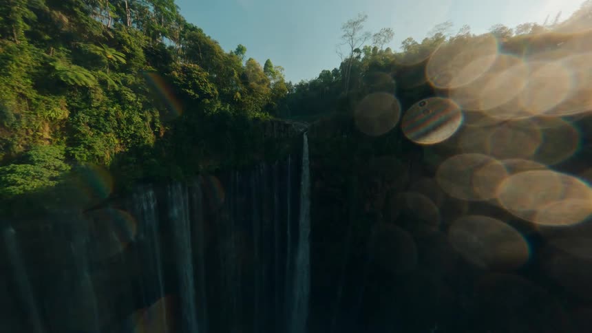 An aerial view of a waterfall in a jungle