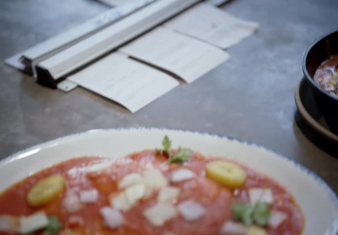 Pasta dish with tomato sauce cheese and cherry tomato slices