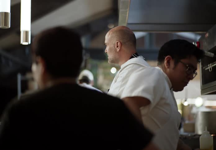 Chef observing the progress of work in the kitchen