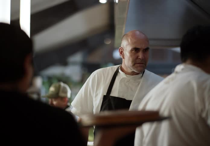 Chef closely observing the team during meal preparation