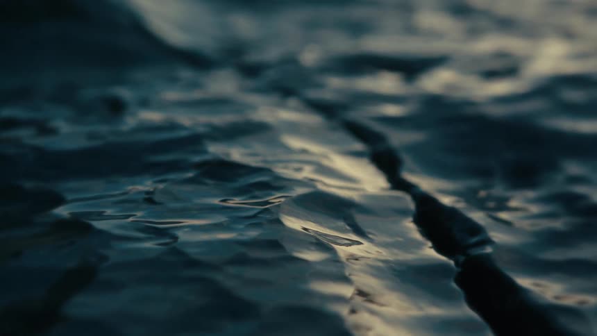 Golden light reflecting on the surface of wet rocks