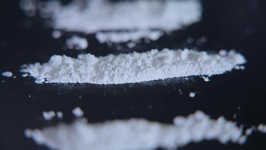 Lines of cocaine on a dark surface