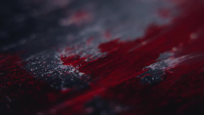 Abstract texture blends shades of red and black with a subtle sheen