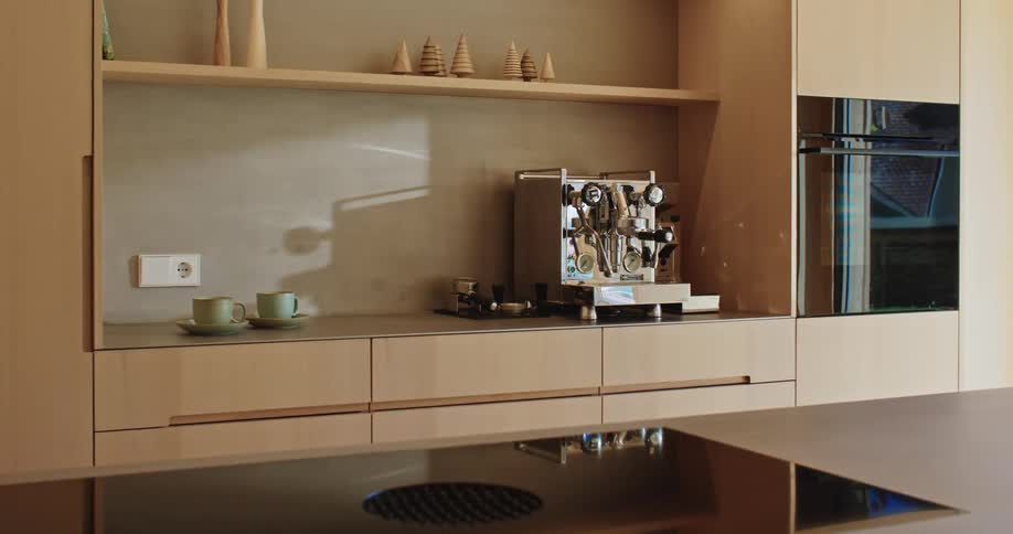 Complicated kitchen appliance sits in a clean modern kitchen during the daytime