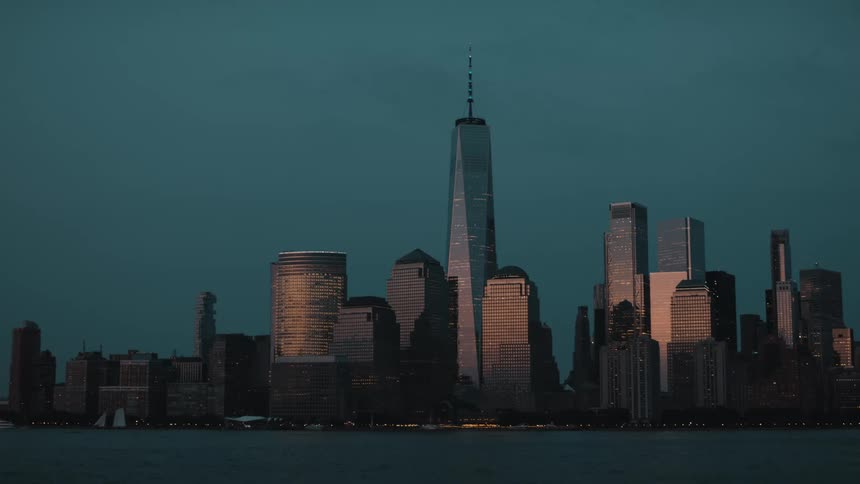 Towers and skyscrapers on the metropolitan coast as boats sail on the water