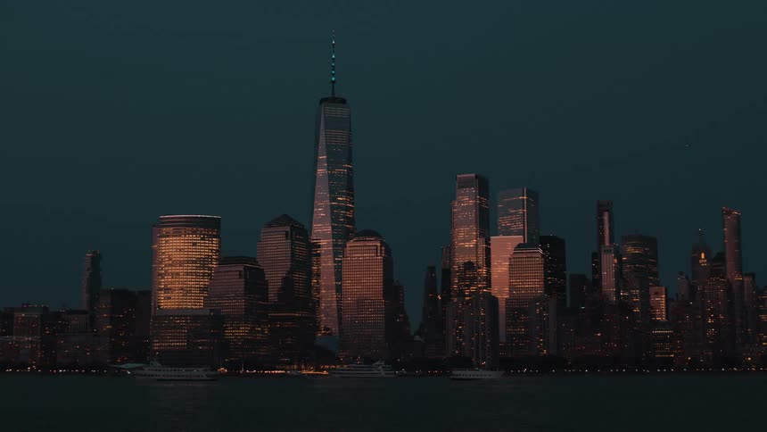 Towers and skyscrapers on the metropolitan coast as boats sail on the water