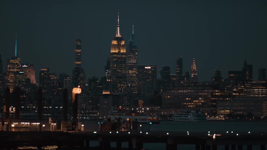 A view of a city of tall buildings at night