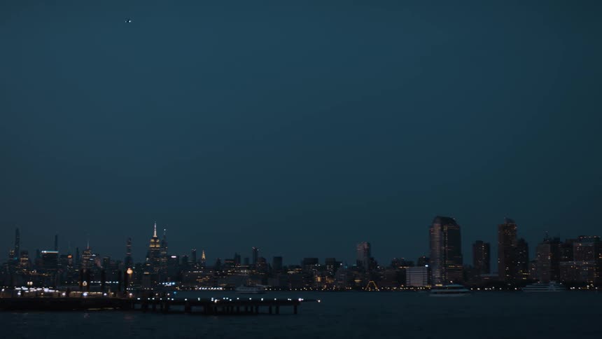 City skyline lit up at dusk viewed from across the river
