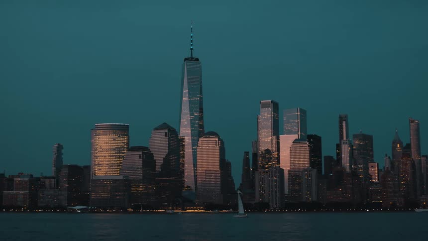 Evening reflections illuminate the glass buildings by the river
