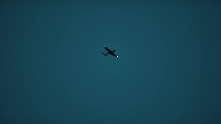 The plane travels in the cloudy sky