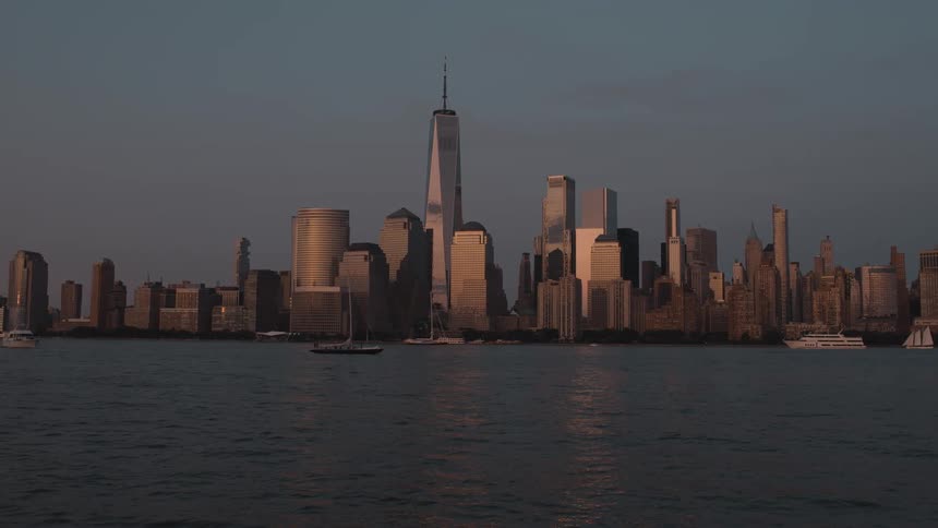 Towers and skyscrapers on the metropolitan coast as boats sail on the water